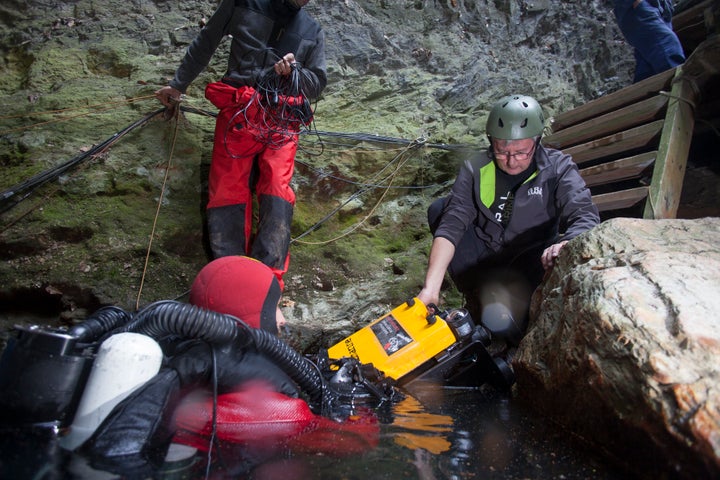 The team of explorers prepare to send the remotely operated vehicle to the cave's bottom.