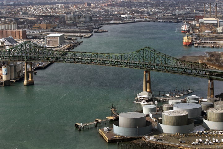 Chelsea oil tanks on the right, with ships on the docks in Everett, upper right. The Tobin Bridge spans the river and Charlestown, Massport on left.