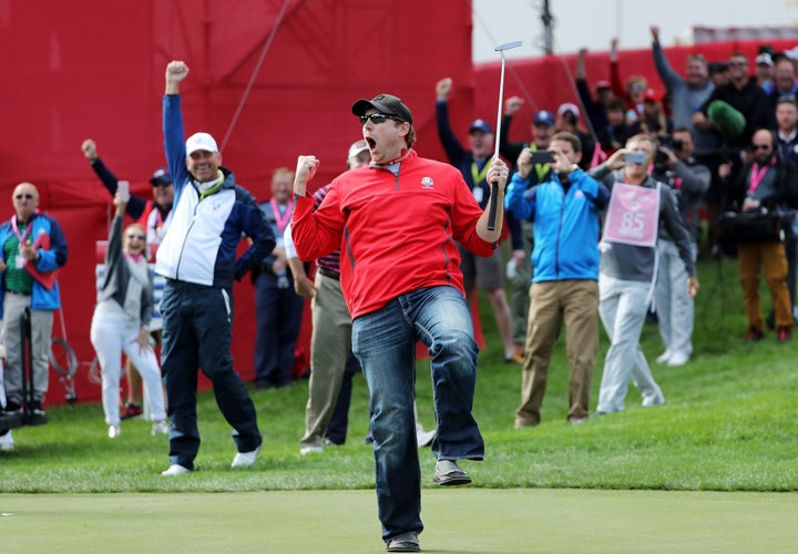 Fan David Johnson of North Dakota reacts after being pulled from the crowd and sinking a putt that pro golfers couldn't.