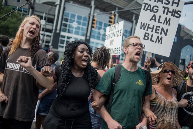 Demonstrators protest outside of Bank of America Stadium before an NFL football game between the Charlotte...
