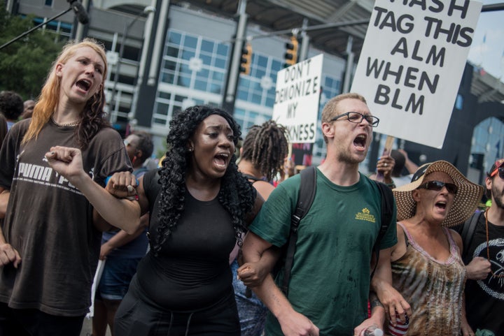 Demonstrators protest outside of Bank of America Stadium before an NFL football game between the Charlotte Panthers and the Minnesota Vikings.