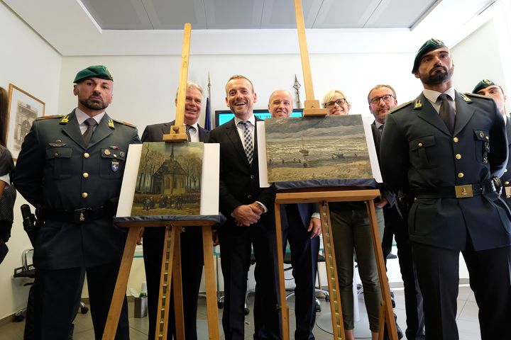 Axel Ruger (C), Director of the Van Gogh museum poses next to the recovered paintings