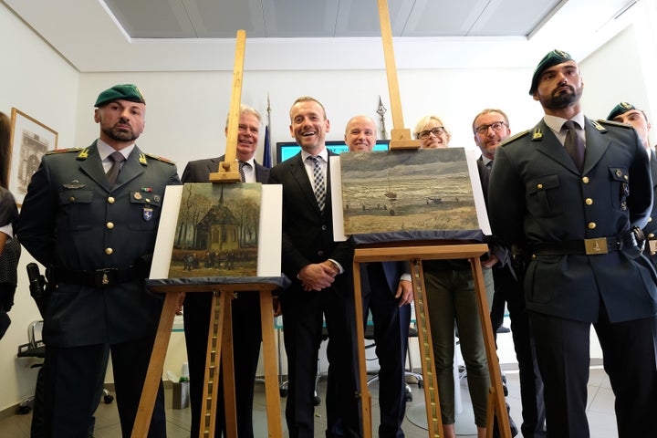 <strong>Axel Ruger (C), Director of the Van Gogh museum poses next to the recovered paintings</strong>