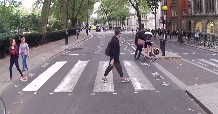 Shocked spectators looked on as the suit-wearing man challenged the cyclist