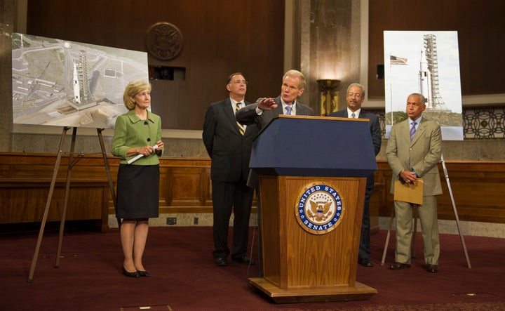 Members of Congress and NASA Administrator Charles Bolden unveil the Space Launch System design in September 2011. From left: Sen. Kay Bailey Hutchison R-Texas, Sen. John Boozman, R-Ark., Sen. Bill Nelson, D-Fla., Rep. Chaka Fattah, D-Pa., Administrator Bolden. 