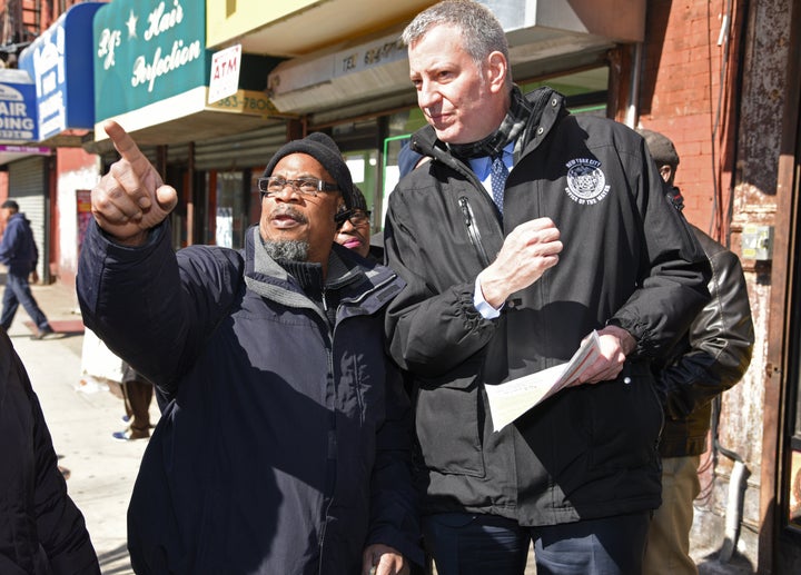 Mayor Bill de Blasio speaks with social worker Irwin Jeffrey, who expressed concern over gentrification and and the rising cost of rent in the neighborhood.