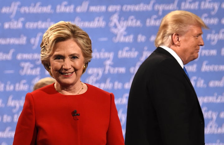 Democratic nominee Hillary Clinton (L) and Republican nominee Donald Trump leave the stage after the first presidential debate.