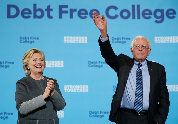 Hillary Clinton, left, and Bernie Sanders wave to the crowd at the conclusion of a campaign event at the University of New Hampshire on Sept. 28, 2016.