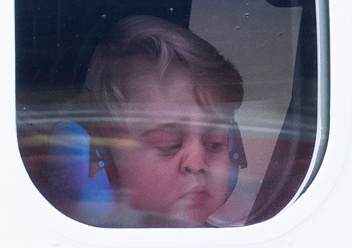 Prince George peers out of his sea plane's window as his family departs Victoria, Canada, on Saturday.