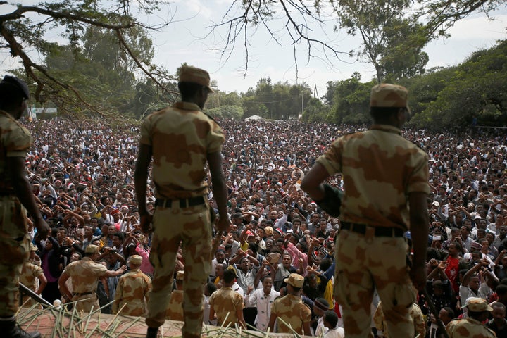 Police officers watch as demonstrators in Bishoftu town, Oromia region, Ethiopia, October 2, 2016