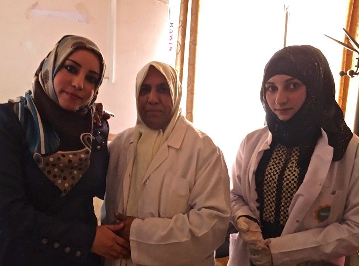Iraqi women, some of them nurses, pose for a photograph at a medical center in Qayyarah. 
