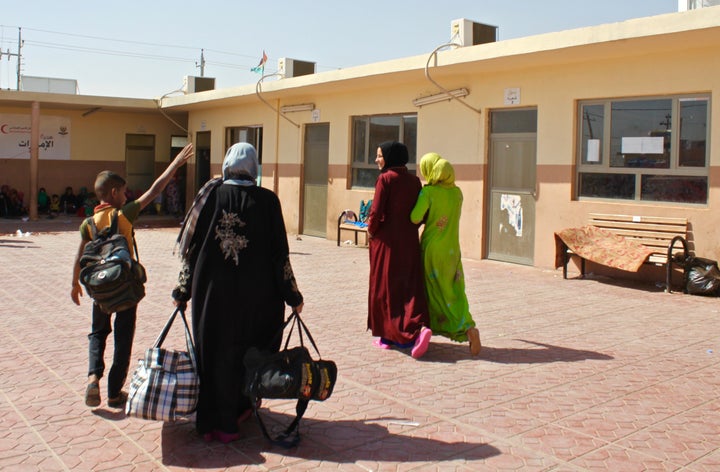 Internally displaced Iraqis from former ISIS-held areas walk through Debaga camp in Iraqi Kurdistan.&nbsp;