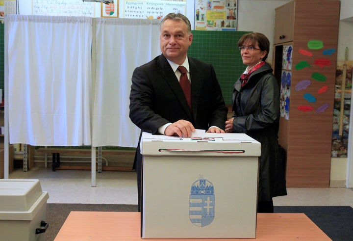 Hungary's Prime Minister Viktor Orban casts his ballot next to his wife Aniko Levai inside a polling station during a referendum on EU migrant quotas in Budapest, Hungary, October 2, 2016.