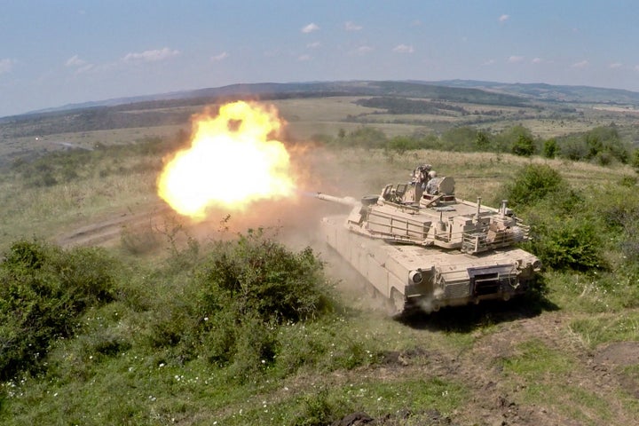 An Army Abrams tank hurls a 48-pound armor-piercing projectile in training for high-intensity warfare.