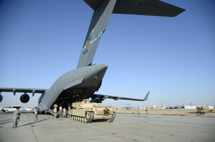 An Air Force C-17 unloads an Abrams tank at an undisclosed location.