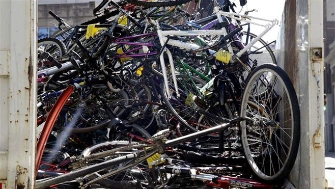 Some cities are turning an eyesore into money by taking abandoned bikes and auctioning them off, while others are giving them to nonprofits that refurbish them. Above, a pile of abandoned bicycles in a cleanup truck in Philadelphia.