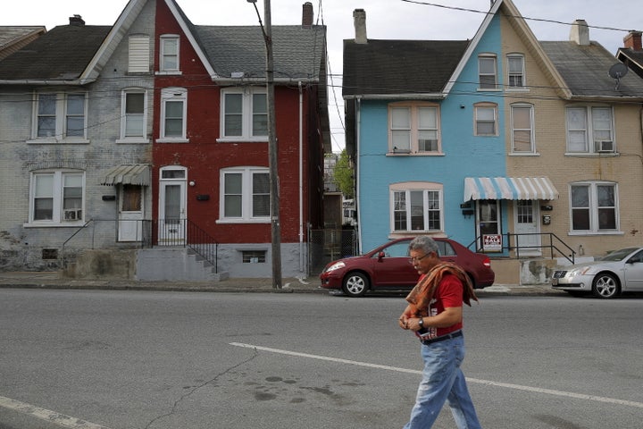 A man walks past multicolored homes that face the now-closed Bethlehem Steel mill in Bethlehem, Pennsylvania, on April 22, 2016. Bethlehem lost at least $55 million on swap deals.