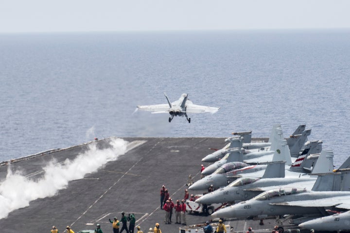 A U.S. FA/A-18 Super Hornet takes off from the deck of the carrier Harry <br>S. Truman to strike targets in the Middle East.