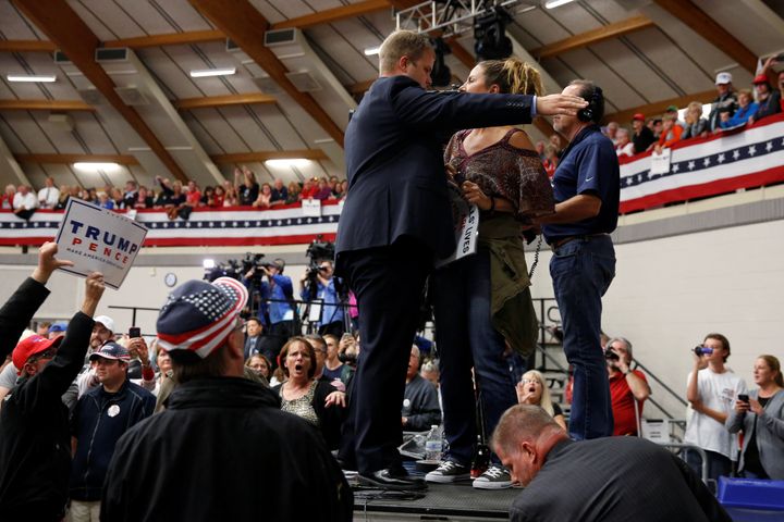 A protester is escorted out after she disrupted a rally with Republican presidential nominee Donald Trump and his supporters in Waukesha, Wisconsin. 