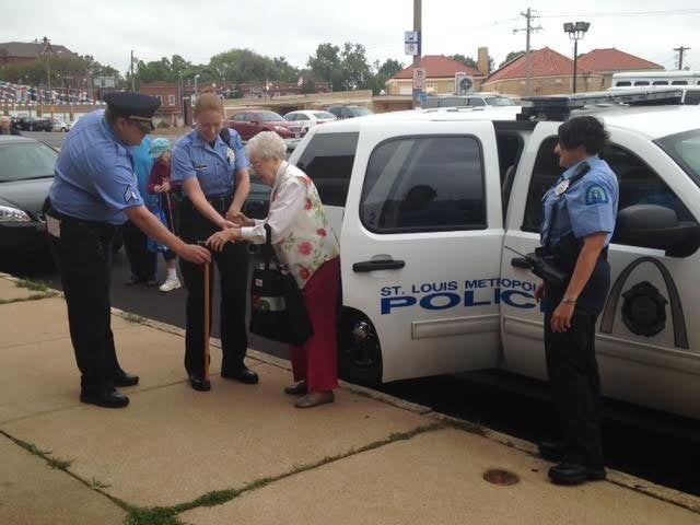 Edie Simms is seen being helped out of a police car following a fun-filled ride on Friday.