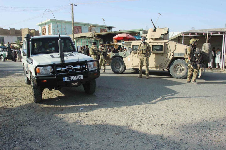 Afghan security forces keep watch in front of their armored vehicle in Kunduz city, Afghanistan on October 4, 2016.