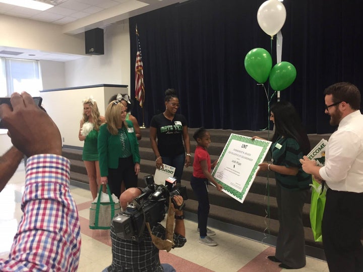 Jordin Phipps, in red, receiving her award during an assembly at her elementary school Sept. 29.