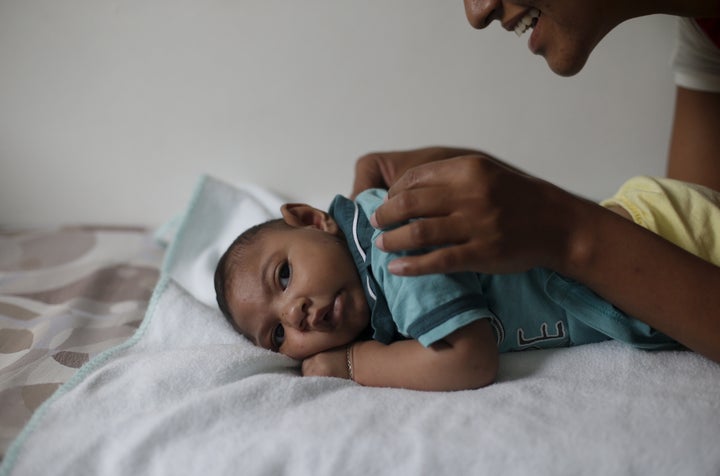 Mariam Araujo, 25, plays with Lucas, her 4-months old second child and born with microcephaly as they wait for a physiotherapy session in Pedro I hospital in Campina Grande, Brazil, February 17, 2016.