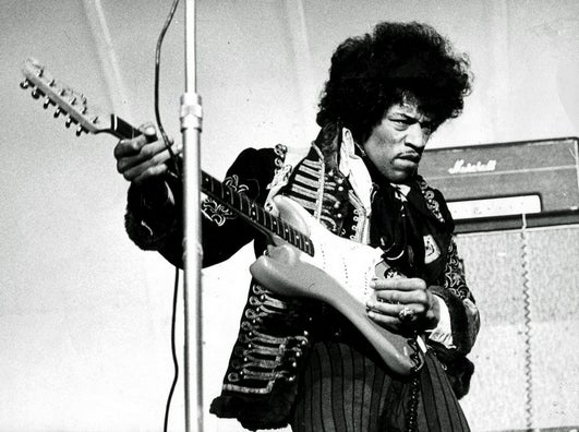Jimi Hendrix performs on stage in 1967.