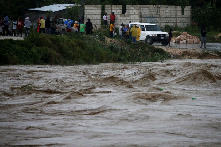 Water rises in a river in Port-au-Prince, Haiti as rains caused by Hurricane Matthew cause flooding.