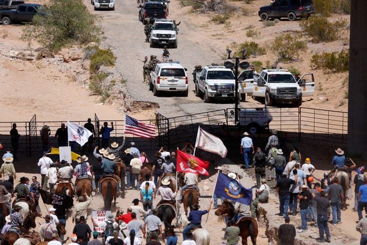 Protesters gather at the Bureau of Land Management's base camp, where cattle that were seized from rancher Cliven Bundy are being held, near Bunkerville, Nevada April 12, 2014.