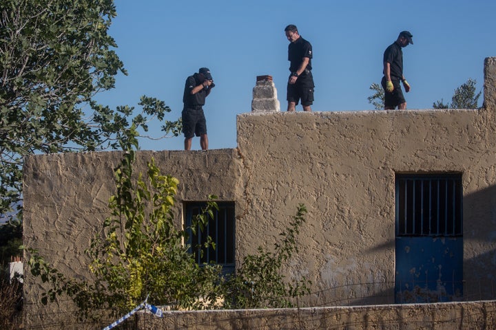 South Yorkshire Police work on the rooftop of the farmhouse at the excavation site