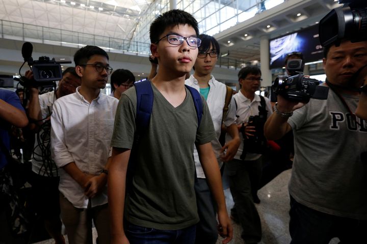 Pro-democracy activist Joshua Wong, followed by Demosisto Chairman Nathan Law (L), arrives at Hong Kong Airport in Hong Kong, China October 5, 2016, after being deported from Bangkok.
