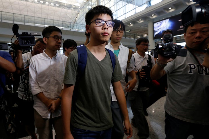 Pro-democracy activist Joshua Wong, followed by Demosisto Chairman Nathan Law (L), arrives at Hong Kong Airport in Hong Kong,