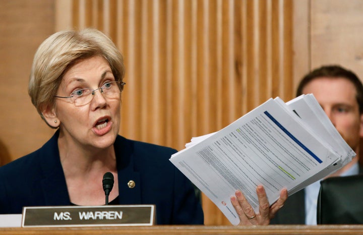 U.S. Senator Elizabeth Warren (D-MA) shows company documents to Wells Fargo CEO John Stumpf during his testimony before a Senate Banking Committee hearing on the firm's sales practices on Capitol Hill in Washington, U.S., September 20, 2016.