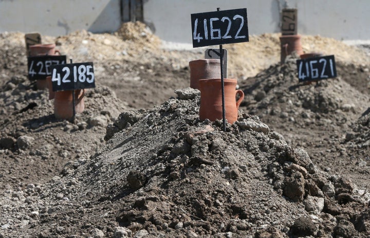 Tombstones are placed on graves of unidentified 85 refugees, mostly women and children, who drowned at sea during an attempt