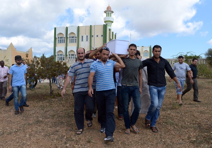 The body of one of the victims of the recent tragedy off Lampedusa is carried to the burial ground behind the mosque in Paola