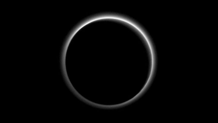 New Horizons’ goodbye image of Pluto, backlit by the sun as the spacecraft passes to the other side of the planet on July 15, 2015.
