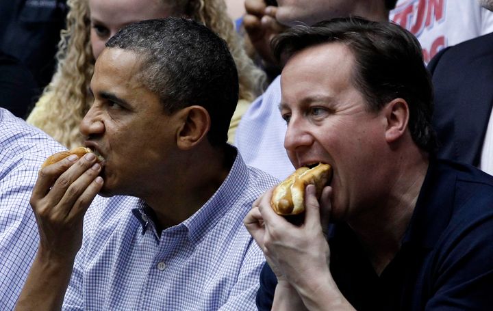 Obama eating a hot dog with British Prime Minister David Cameron.
