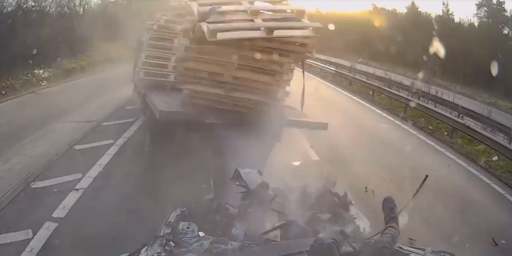 The legs of a motorist can be seen hanging out of his windscreen (bottom right) after a crash near Canterbury caused by a truck failing to slow after tailbacks 