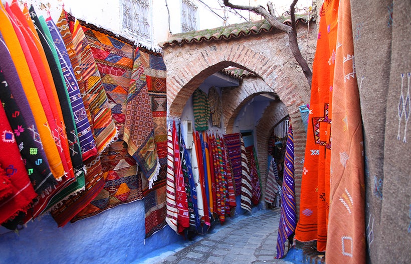 Colourful wool woven fabrics line the streets of Chefchaouen, Morocco