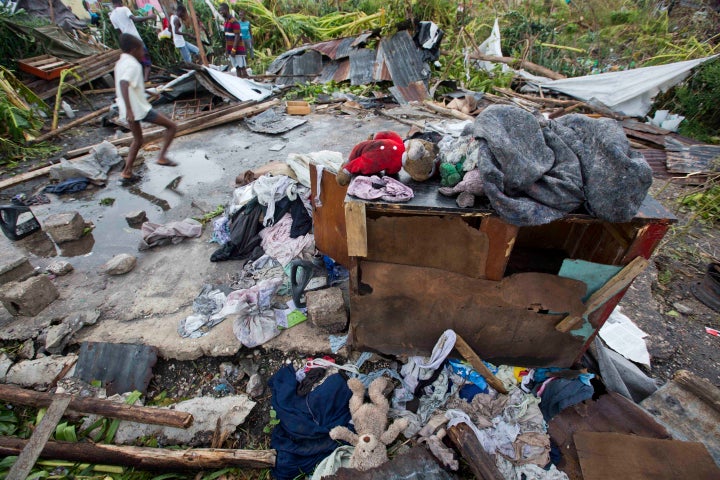 Personal items lie scattered outside homes destroyed by Hurricane Matthew in Les Cayes, Haiti, Thursday, Oct. 6, 2016.