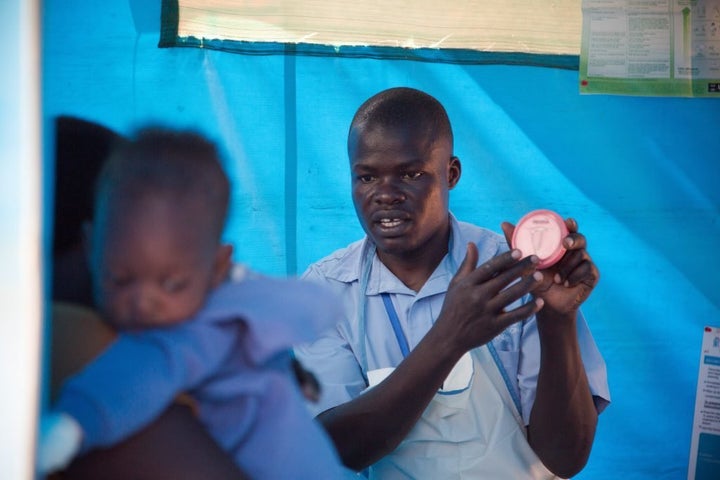 A Marie Stopes counsellor shows a young mother a long-term contraceptive. To try to tackle Uganda’s high rate of unsafe