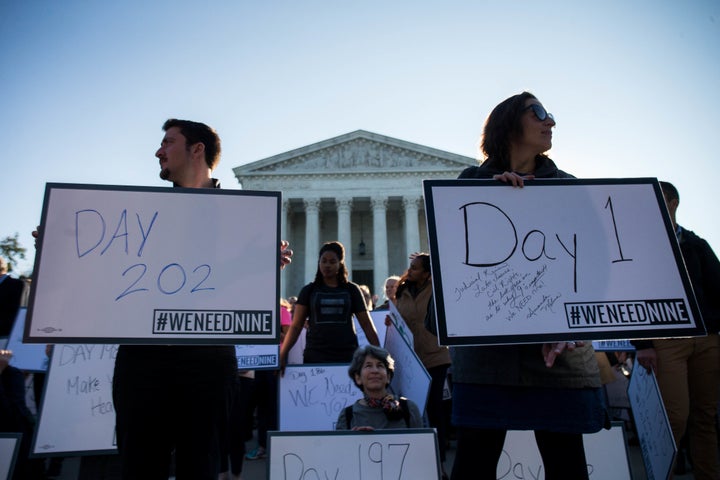 Demonstrators urge members of the Senate to hold a confirmation vote for Supreme Court nominee Merrick Garland on Oct. 4