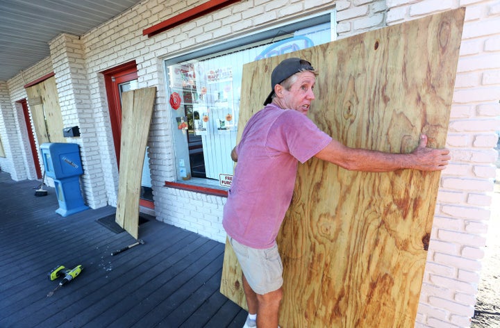 A man boards up a house in Cape Canaveral ahead of Matthew's anticipated arrival on Thursday evening.