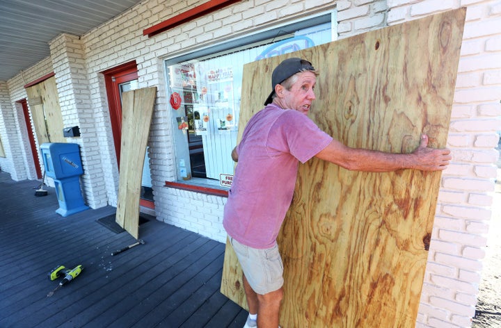 A man boards up a house in Cape Canaveral ahead of Matthew's anticipated arrival on Thursday evening. 