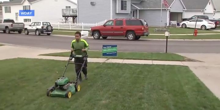 Brandon mowing lawns.