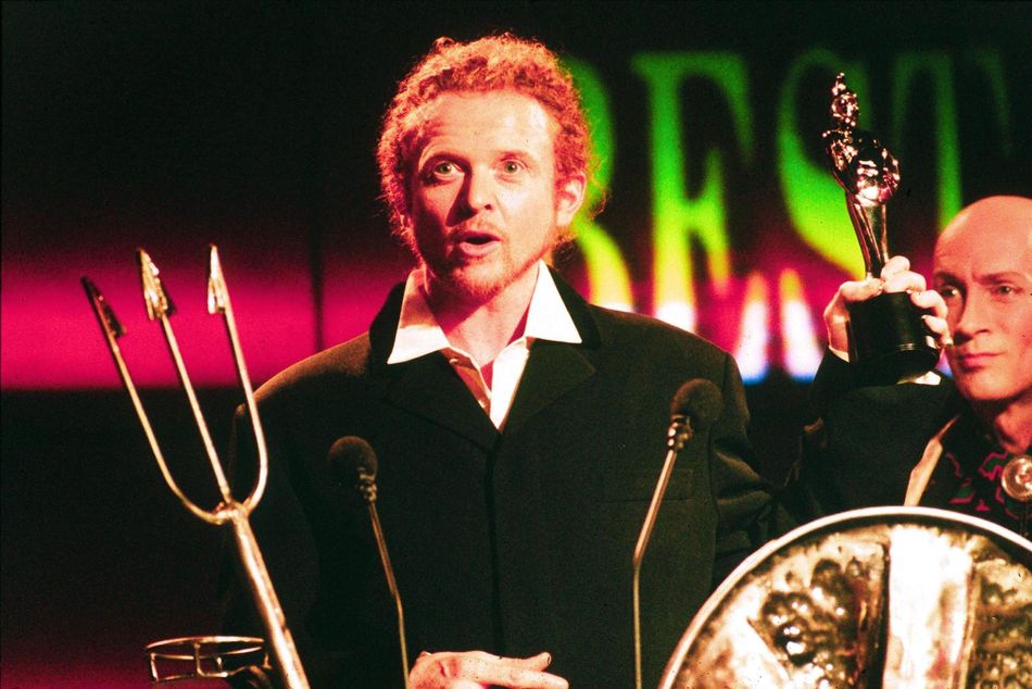 Mick Hucknall's win was doubly surprising when you take into account that he beat competition from Eric Clapton, George Michael, Sir Elton John and Phil Collins to win Best British Male.And yes, that's Richard O'Brien of Crystal Maze and Rocky Horror fame in the background who, for some reason, was the host that year.