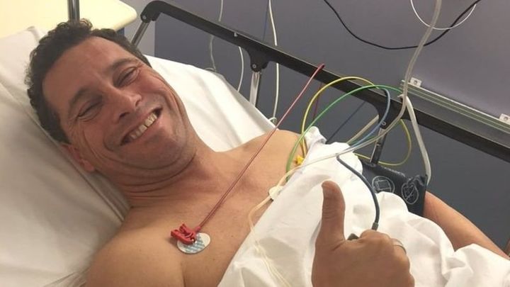 <strong>Woolfe gives the thumbs up from his hospital bed</strong>
