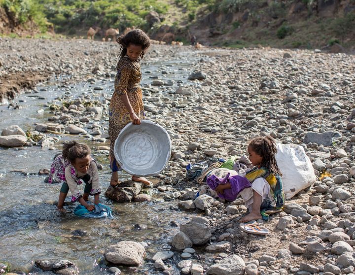 Mahoni, Ethiopia - October 13: Girls washing clothes in a Creek on October 13, 2015 in Mahoni, Ethiopia.