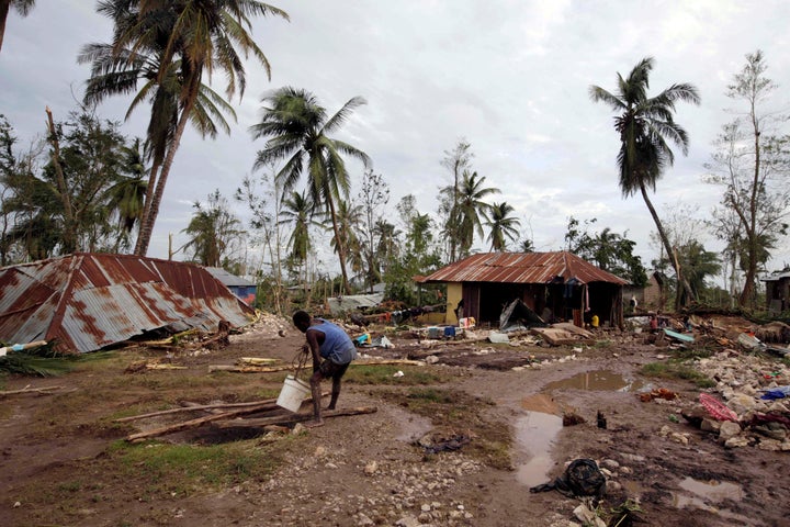 A man gets water from a well in an area destroyed by Hurricane Matthew in Cavaillon, Haiti, Oct. 6, 2016.